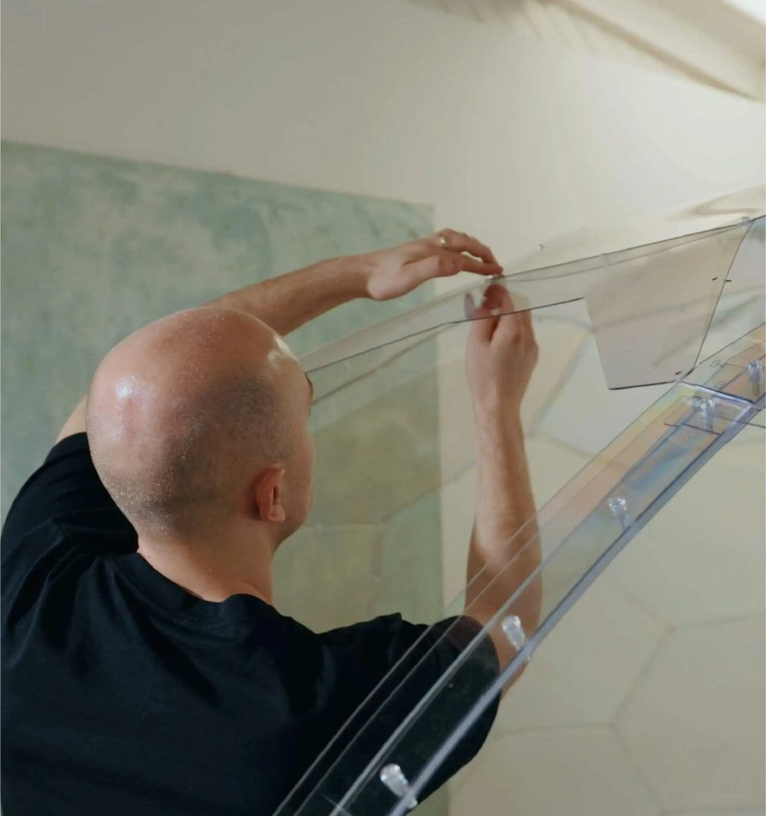 A GeoDomeX installer bolting a numbered panel into place