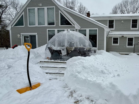 A GeoDomeX dome standing in deep snow in a back garden